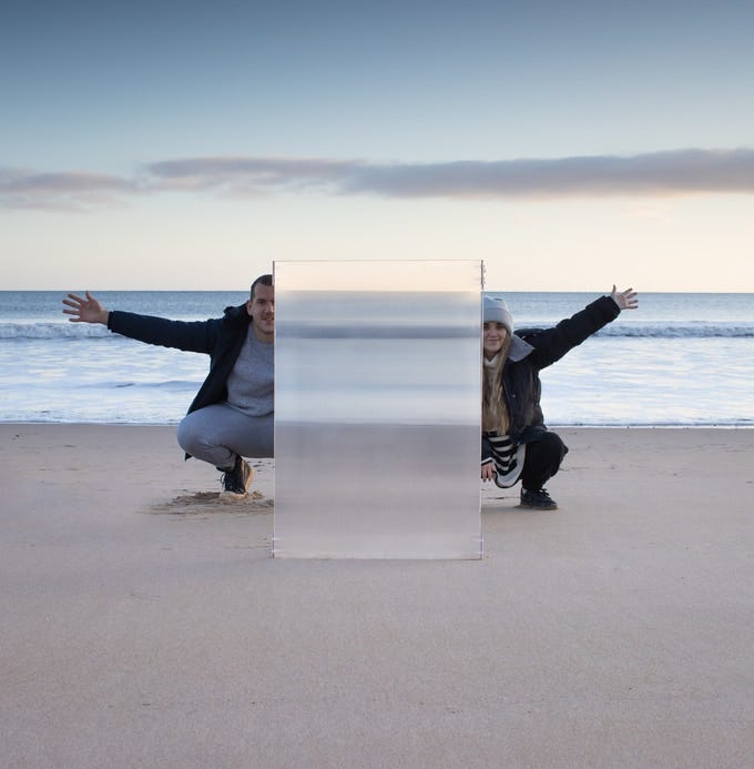 Two people behind invisibility shield