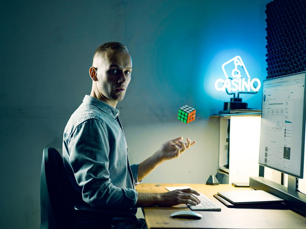 YouTube magician Jack Rhodes sitting at desk with YouTube creator stats open on computer