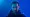 Magician Dynamo (Steven Frayne) in blue studio with dramatic lighting on face