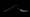 A bent spoon with a snapped point against a black background