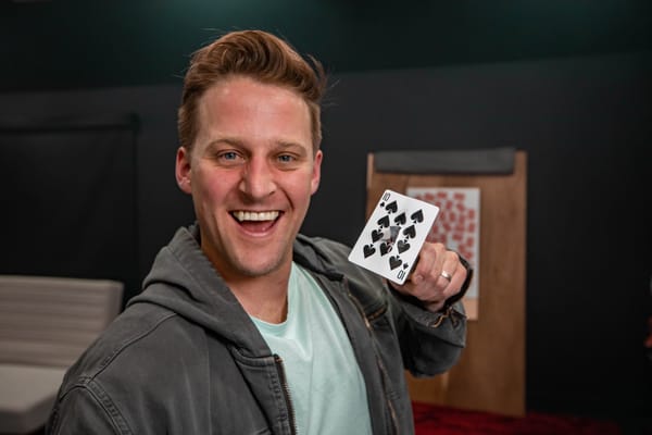 Comedy Stunt Magician Wes Barker with playing card pierced on finger
