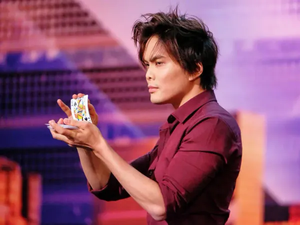 Sleight-of-hand magician and Got Talent winner Shin Lim dribbles playing cards between hands on stage
