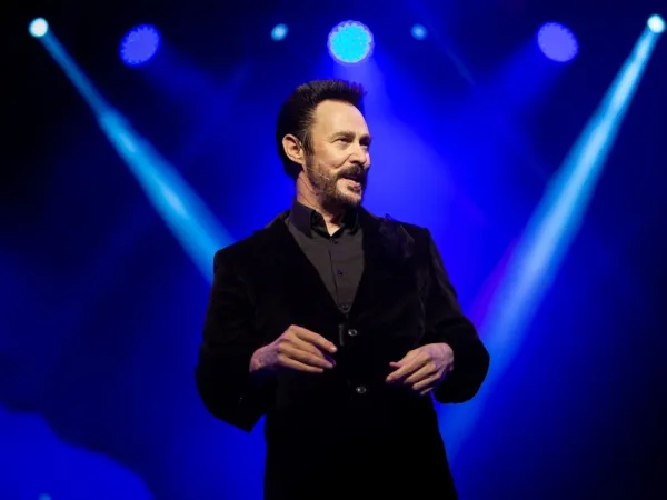 Las Vegas magician and illusionist Lance Burton on stage surrounded by blue lights