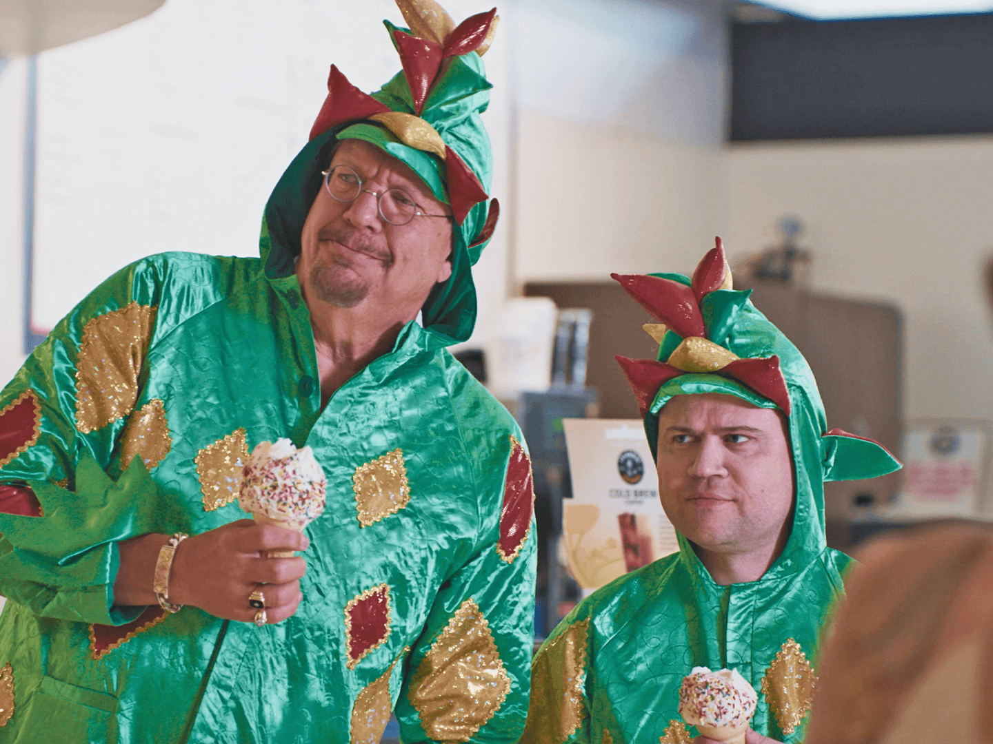 Penn Jillette & Piff both in dinosaur costumes holding ice cream cones