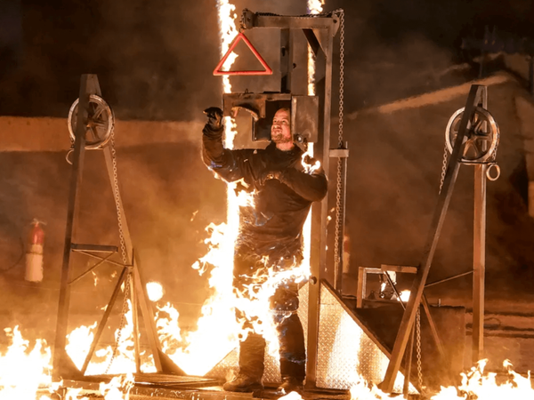 Stunt performer Jonathan Goodwin makes a daring escape from a trap on with fire surrounding him.