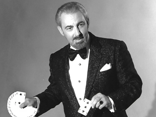 Magician David Berglas during a magic performance with a deck of cards fanned