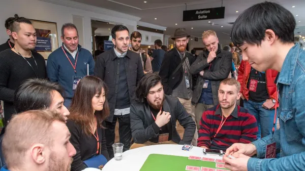 Photo of the session convention magicians jamming close-up tricks with Dynamo watching in awe